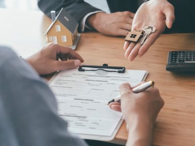 A person handing over keys to a house to another person as collateral for a Loan Against Property Dubai